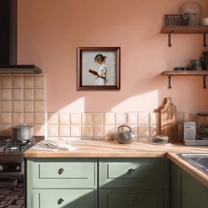 Pu&ograve; includere: Un'opera d'arte incorniciata raffigura una persona che legge un libro, su uno sfondo neutro. L'opera &egrave; racchiusa in una cornice di legno marrone scuro. L'ambiente della cucina presenta mobili verdi, un piano di lavoro in legno e una parete color pesca.