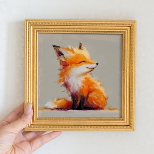 May include: A framed painting of a smiling fox with orange and white fur. The fox is sitting, and the painting has a gold frame. The background is a light gray color.