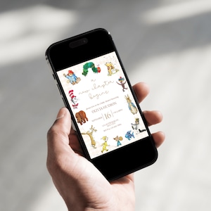 May include: A smartphone displays a baby shower invitation with a whimsical design. The invitation features illustrations of storybook characters and the text "a new chapter begins." The date is September 16th.