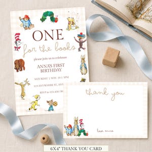 May include: A rectangular birthday invitation and a thank you card featuring illustrations of storybook characters. The invitation text reads ONE for the books, please join us to celebrate ANNA'S FIRST BIRTHDAY, SATURDAY, NOV. 10, 3PM.