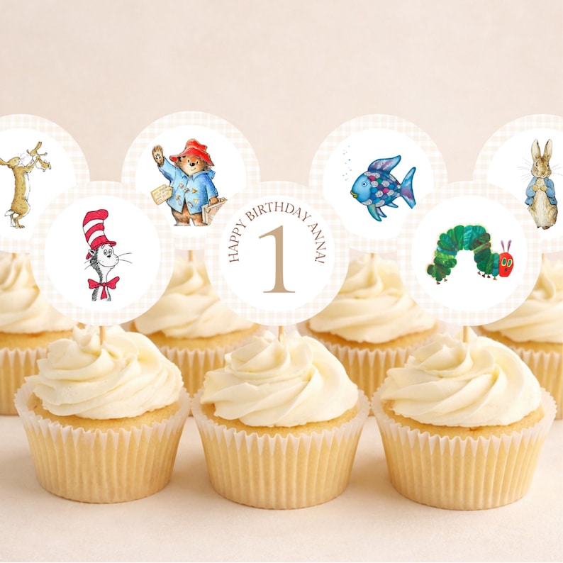 May include: A collection of cupcakes topped with circular paper toppers featuring illustrations of storybook characters including a cat in a hat, a bear, a fish, a caterpillar, and a rabbit, with one topper reading Happy Birthday Anna 1.