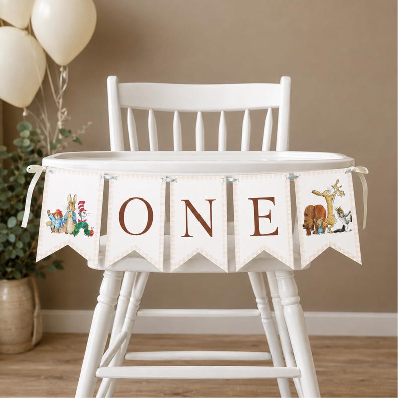 May include: A white high chair features a decorative banner with five pennants. The center three pennants display the brown letters O, N, and E. The outer pennants feature colorful illustrations of various storybook characters.