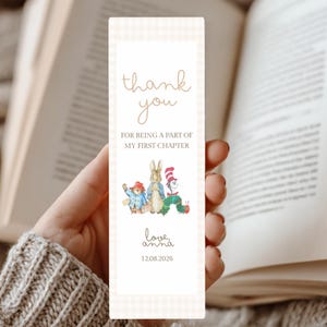 May include: A rectangular bookmark with a light beige gingham border. It features the text "thank you FOR BEING A PART OF MY FIRST CHAPTER", illustrations of storybook characters, "love, anna", and the date "12.08.2026" in brown ink.