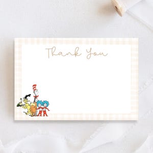 May include: A folded thank you card with a light beige gingham border. The words "Thank You" are written in a delicate script. The card features illustrations of characters from a children's book.