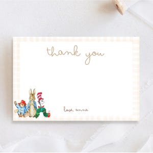 May include: A rectangular thank you card with a light beige gingham border. The text thank you is centered at the top, and love, anna is printed at the bottom right. Watercolor illustrations of Paddington Bear, Peter Rabbit, the Cat in the Hat, and the Very Hungry Caterpillar are in the bottom left corner.
