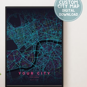 May include: A framed custom city map digital download. The map features a neon blue and purple street grid over a dark background. The text "YOUR CITY" is displayed in pink. A circular graphic reads "CUSTOM CITY MAP DIGITAL DOWNLOAD."