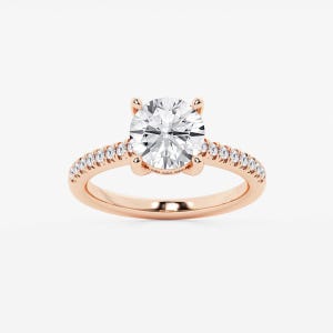 May include: A rose gold engagement ring with a large, round, clear center stone. The band is also rose gold and features a row of smaller, clear stones. The ring is set against a white background.