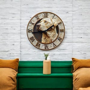 May include: A brown and white clock with a Labrador Retriever dog face on the front. The clock has Roman numerals and is hanging on a white brick wall.