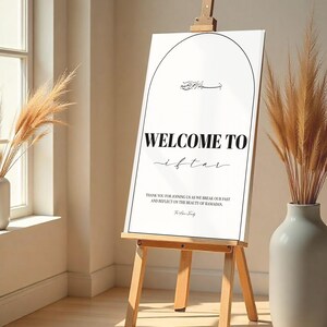 May include: A white sign with black text that reads "WELCOME TO iftar" and "THANK YOU FOR JOINING US AS WE BREAK OUR FAST AND REFLECT ON THE BEAUTY OF RAMADAN." The sign is on an easel.