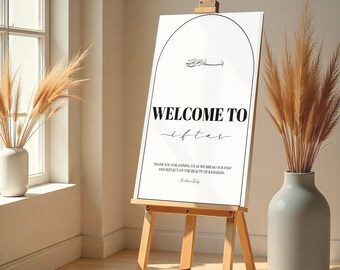May include: A white sign with black text that reads "WELCOME TO iftar" and "THANK YOU FOR JOINING US AS WE BREAK OUR FAST AND REFLECT ON THE BEAUTY OF RAMADAN." The sign is on an easel.