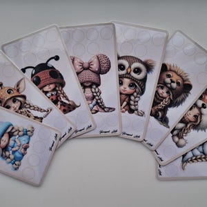 Puede incluir: Un conjunto de tarjetas rectangulares, cada una con una ilustración caprichosa de un niño con un sombrero temático. Los sombreros incluyen un unicornio, una mariquita, una jirafa, un búho, un león, un zorro, un oso y un sombrero con un gran lazo.