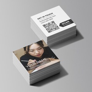 Close-up of premium square business cards printed with nail artist logo and social media QR code in matte finish, ideal for beauty professionals and small salons.