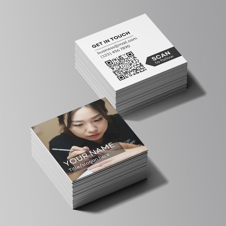 Close-up of premium square business cards printed with nail artist logo and social media QR code in matte finish, ideal for beauty professionals and small salons.