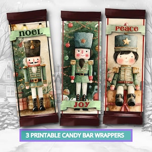 May include: Three rectangular candy bar wrappers featuring watercolor nutcracker illustrations. The left wrapper says NOEL, the center says JOY, and the right says PEACE. Each depicts a nutcracker in a green uniform against a Christmas tree background.