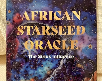 May include: A deck of oracle cards titled "African Starseed Oracle: The Sirius Influence." The card box features a cosmic design with gold lettering, a starry night sky, and an illustration of a figure with flowing hair.