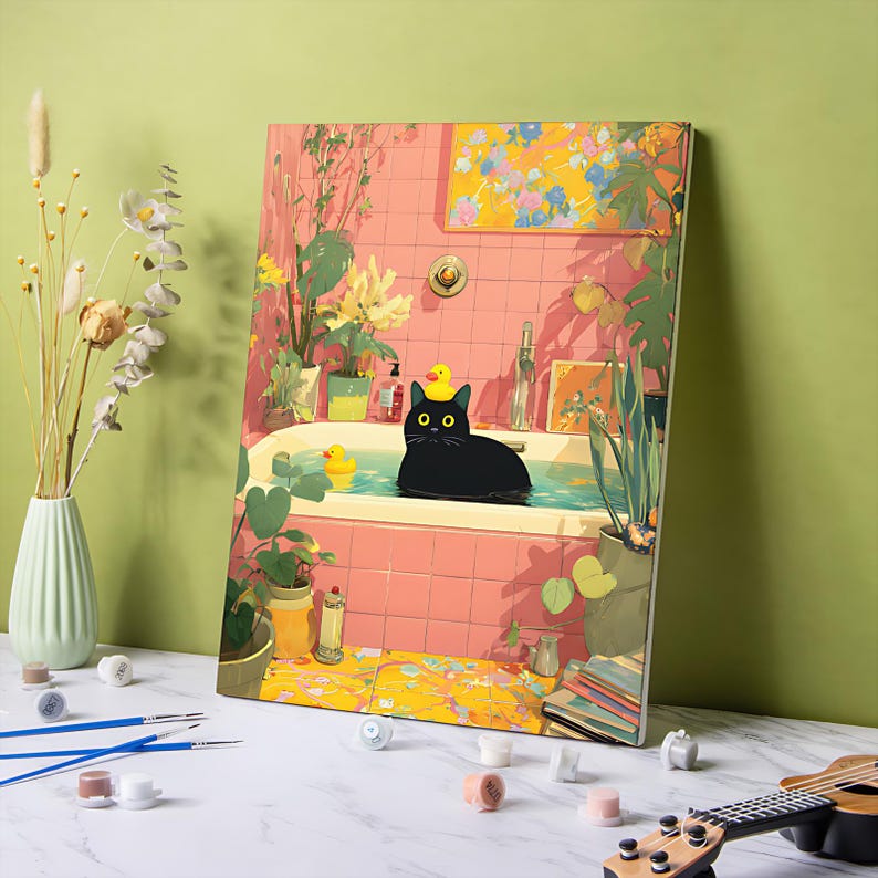 May include: A paint-by-numbers canvas featuring a black cat in a bathtub with a rubber ducky. The bathroom has pink tile, plants, and a yellow floral painting. Paintbrushes, paint pots, and a ukulele are in the foreground.