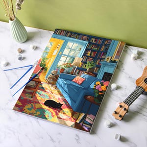 May include: A paint-by-numbers kit featuring a colorful interior scene with a blue sofa, bookshelves, and a black cat. Includes paintbrushes, paint pots, and a ukulele. The artwork depicts a cozy living room with a sunny window.