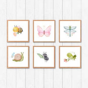 May include: Six framed prints featuring watercolor illustrations of various insects and animals. The prints include a bee, butterfly, dragonfly, snail, ant, and grasshopper. Each print has a white background and is framed in a light wood frame.