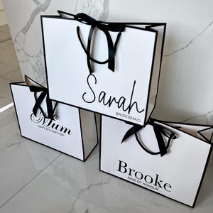 Personalised white gift bag with custom name and elegant rope handles, ideal for bridal party gifts