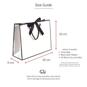 K&ouml;nnte beinhalten: Wei&szlig;e Geschenkt&uuml;te mit schwarzem Satinband und schwarzen Tragegriffen. Die Tasche misst 11 cm in der Breite, 32 cm in der L&auml;nge und 25 cm in der H&ouml;he. Wird flach zum einfachen Zusammenbauen geliefert.