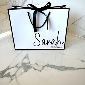 Customisable white gift bag with a beautiful ribbon bow and rope handles, perfect for bridesmaid proposals and engagement celebrations