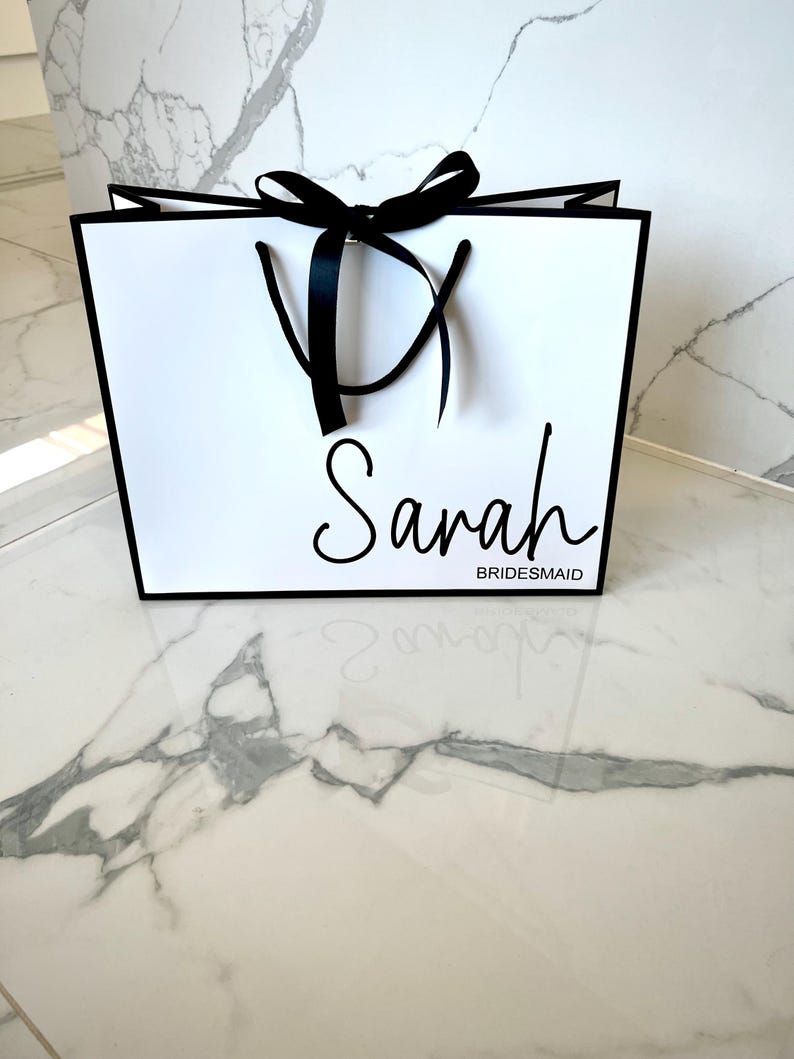 Customisable white gift bag with a beautiful ribbon bow and rope handles, perfect for bridesmaid proposals and engagement celebrations