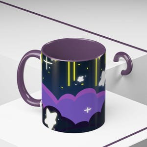 May include: Purple mug with a black and purple night sky design featuring white stars, yellow streaks of light, and white clouds.
