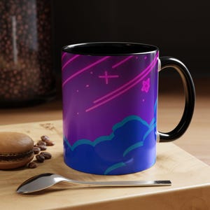 May include: A black coffee mug with a purple, blue, and pink galaxy design. The design features clouds, stars, and a plus sign.
