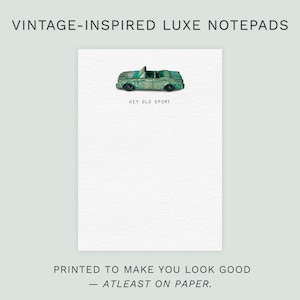 May include: A white notepad with a vintage design. A small, green toy car is on the page, with the words "HEY OLD SPORT" printed below. The text "PRINTED TO MAKE YOU LOOK GOOD - ATLEAST ON PAPER" is at the bottom.