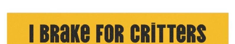 May include: Yellow sign with black text that reads "I Brake For Critters".