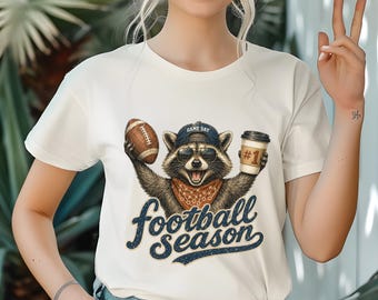 Raccoon Holding Football and Coffee Football Season TShirt | Sports Fan Tee