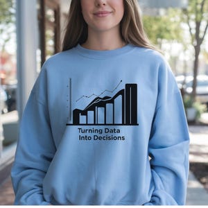 May include: A light blue sweatshirt with a black graphic of a rising graph and the text "Turning Data Into Decisions". The sweatshirt is made of a soft material.