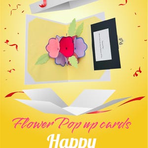 May include: A pop-up greeting card featuring a multi-coloured paper flower bouquet in shades of red, pink, and purple with green leaves. The card includes a black pull-tab with the text Pull and the printed text Flower Pop up cards Happy Birthday.