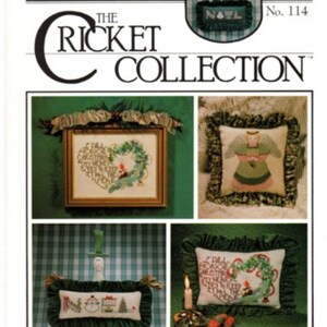 May include: A collection of four cross-stitch patterns for pillows featuring winter and Christmas themes. The patterns include a wreath with the words "I shall honor Christ in my heart and keep His precepts in the home", a snowman with the word "Noel", an angel with a star, and a wreath with the words "I shall honor Christ in my heart and keep His precepts in the home".