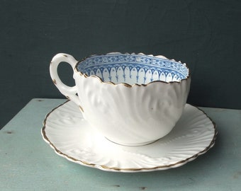 Antique china tea cup and saucer - white ceramic blue transferware fluted edges - embossed floral pattern - small cabinet cup and saucer