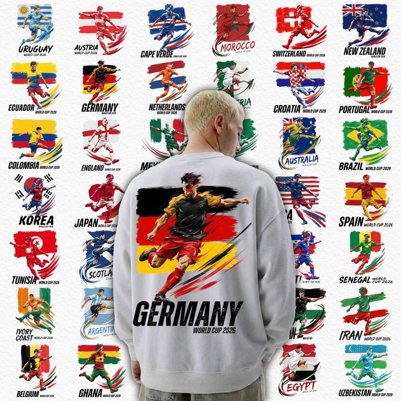 Op de afbeelding: Wit sweatshirt met een voetballer en het woord "GERMANY" in zwart, met "WORLD CUP 2026" eronder. Het ontwerp bevat vlaggen en voetballers die verschillende landen vertegenwoordigen.