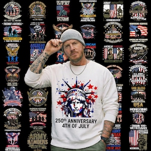 May include: White sweatshirt featuring a graphic of the Statue of Liberty with red and blue stars and the text "250th Anniversary 4th of July." Surrounding the main image are various patriotic designs and text related to veterans and the U.S. military.