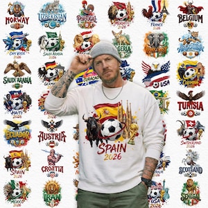 May include: A white sweatshirt with a graphic of a soccer ball, a bull, and the text "SPAIN 2026". Surrounding the person are various country emblems with soccer balls, flags, and text, including "USA", "France", and "Germany".