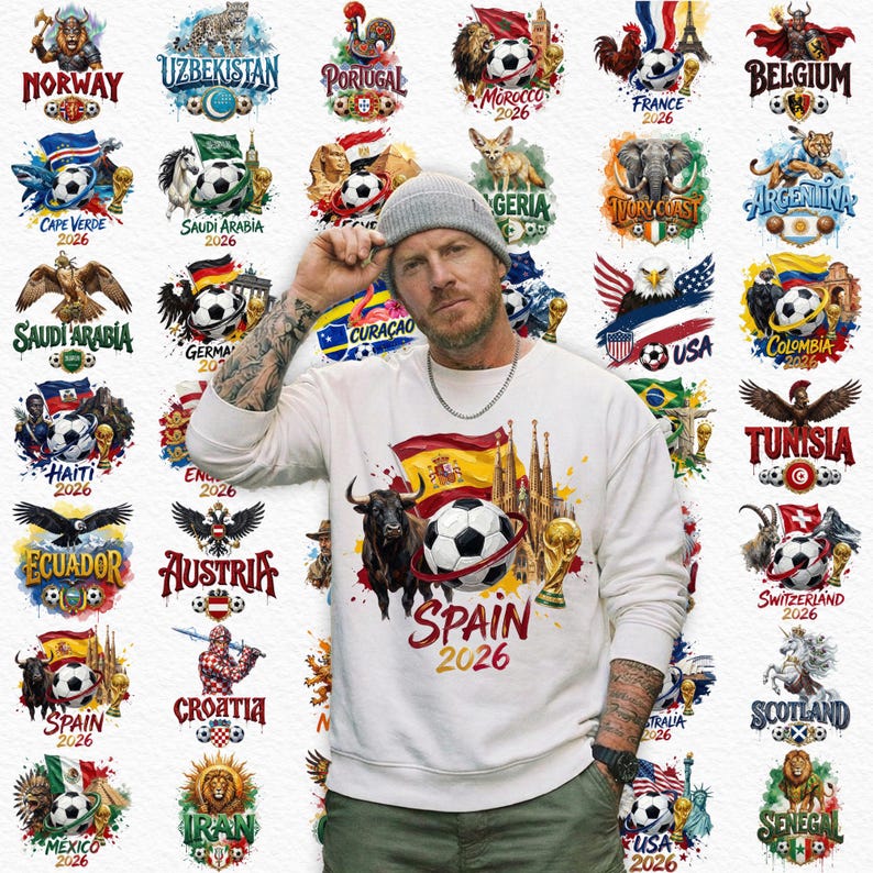 May include: A white sweatshirt with a graphic of a soccer ball, a bull, and the text "SPAIN 2026". Surrounding the person are various country emblems with soccer balls, flags, and text, including "USA", "France", and "Germany".