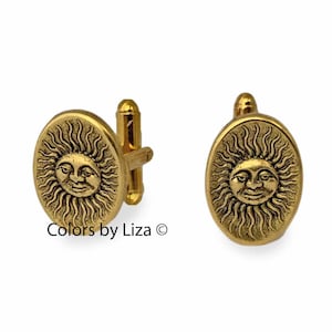 May include: Gold-toned cufflinks with a sun face design. The sun has a smiling face and rays emanating from it.