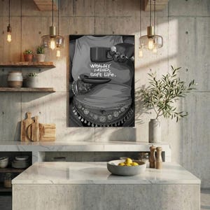 May include: Black and white print of a person holding a cup and saucer. The person is wearing a tank top with the words "WEALTHY MIND, SOFT LIFE." The person is also wearing jewelry.