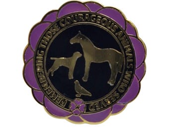 May include: Purple and gold enamel pin with a black background. The pin features a horse, dog, and dove with the text "Remembering Those Courageous Animals Who Served".