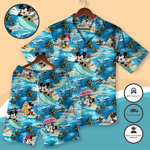 May include: A blue and white Hawaiian shirt and matching shorts featuring a repeating pattern of Mickey Mouse surfing on waves with palm trees.