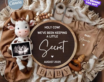 May include: A baby announcement with a plush cow holding an ultrasound image. The announcement includes a brown onesie, baby booties, wooden blocks spelling "BABY", and a sign that reads "Holy Cow! We've been keeping a little secret August 2025."