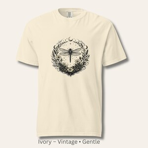 Flat lay of a Comfort Colors 1717 t-shirt in Ivory with the Dragonfly Sigil and botanical artwork. Warm, vintage, parchment-like tone. Garment-dyed cotton with soft texture. Perfect for intuitive women and symbolic, nature-coded style.