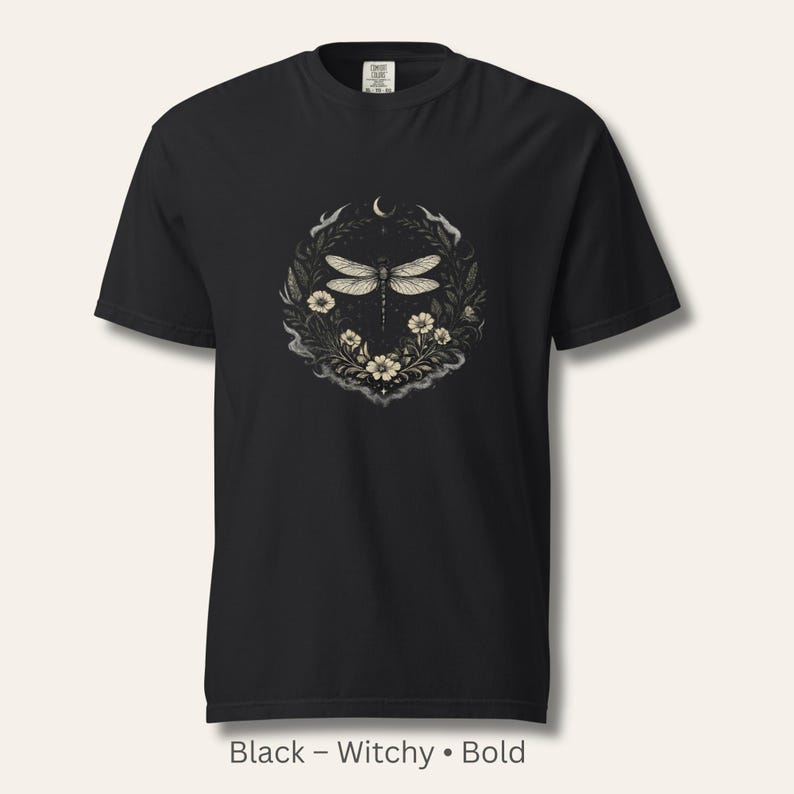 Flat lay of a Comfort Colors 1717 t-shirt in Black featuring the Dragonfly Sigil with botanical linework and crescent moon. Garment-dyed, vintage-washed cotton. Witchy, dark feminine aesthetic. Perfect for intuitive women, nature lovers, and symbolic wardrobe pieces.