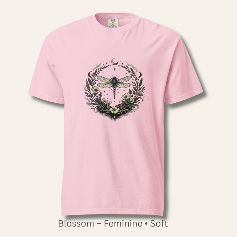 Flat lay of a Comfort Colors 1717 t-shirt in Blossom pink with the Dragonfly Sigil and botanical illustration. Feminine, soft-dark, witch-coded aesthetic. Garment-dyed cotton with vintage softness. Perfect for emotional healing and intuitive style.