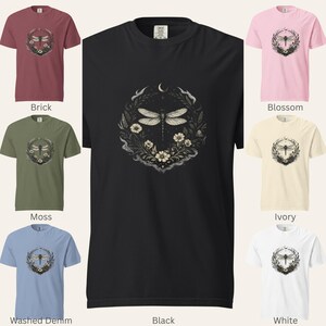 Grid of Comfort Colors 1717 t-shirts in seven shades: Black, Brick, Moss, Washed Denim, Blossom, Ivory, and White. Each shirt features the Dragonfly Sigil with botanical elements and a crescent moon. Garment-dyed, vintage washed, soft dark aesthetic. Perfect for witchy, intuitive, nature-coded style.