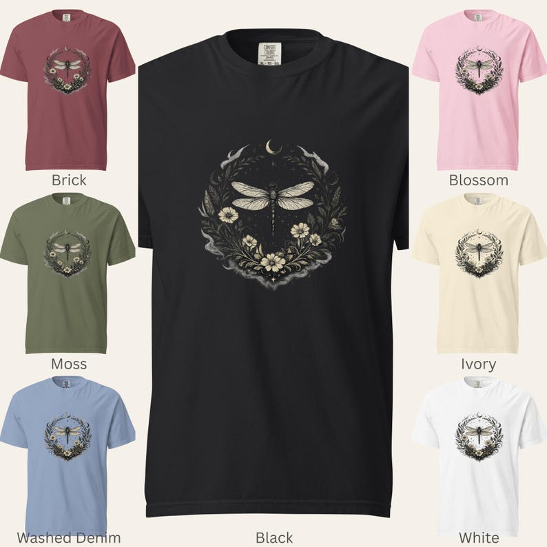 Grid of Comfort Colors 1717 t-shirts in seven shades: Black, Brick, Moss, Washed Denim, Blossom, Ivory, and White. Each shirt features the Dragonfly Sigil with botanical elements and a crescent moon. Garment-dyed, vintage washed, soft dark aesthetic. Perfect for witchy, intuitive, nature-coded style.