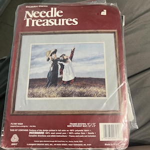 May include: A sealed craft kit titled "Needle Treasures" with a framed image of two children in a field, looking up. The kit includes PATERNAYAN wool crewel yarn and cotton floss. The frame size is 18" x 13", and the image size without the mat is 12" x 9".